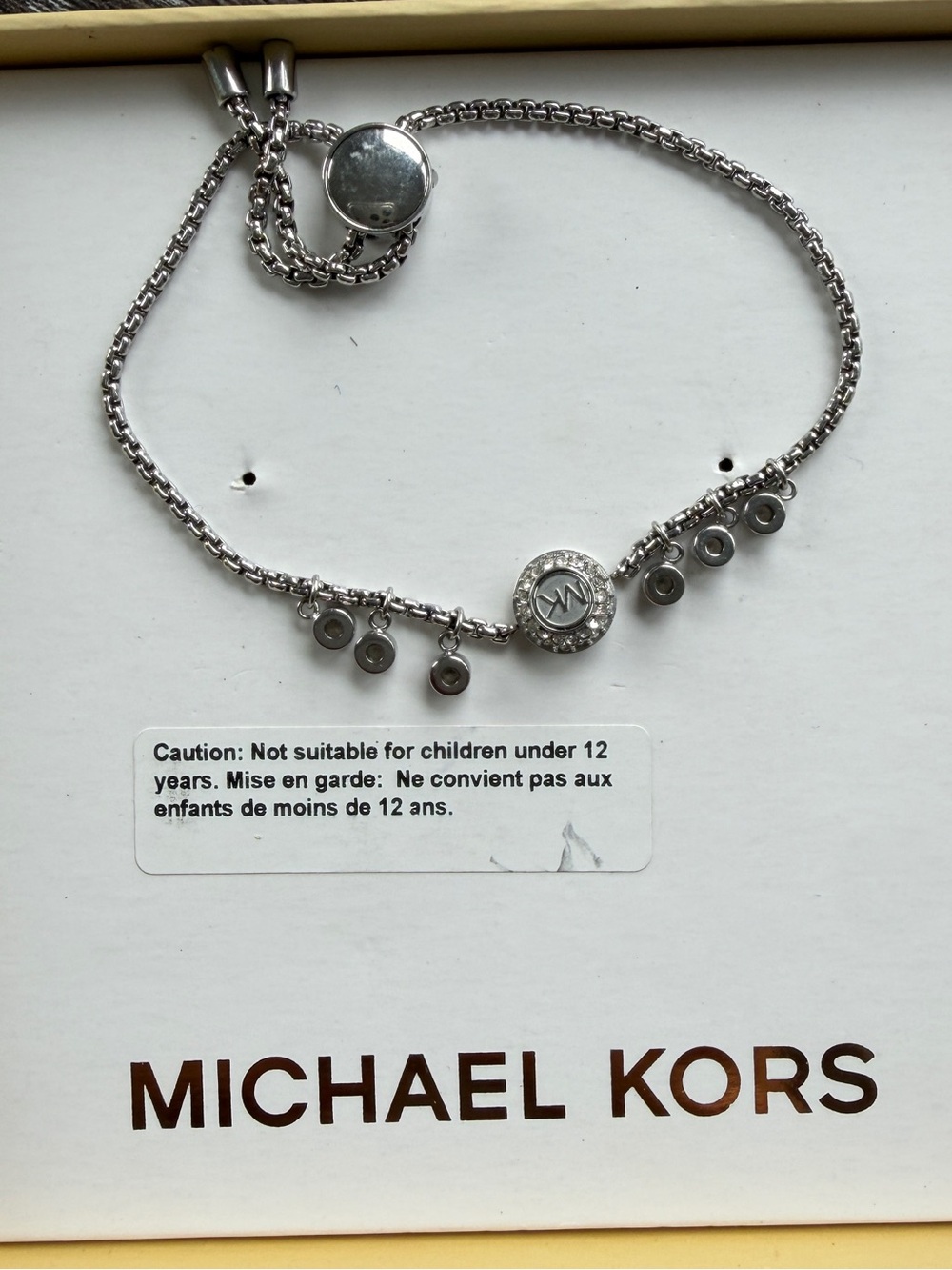 Michael Kors slider bracelet features a central pavé crystal MK logo silver-tone